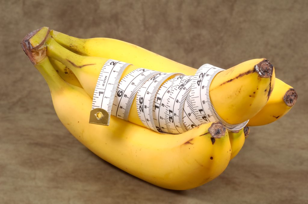 Bananas With a Tape Measure Wrapped Around It. Diet Concept - Clipping Path Included